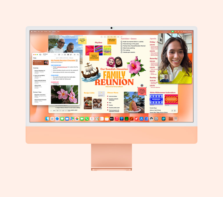 iMac, front exterior, orange color, screen displaying a person on a FaceTime call, a family reunion planning board, and Notes app